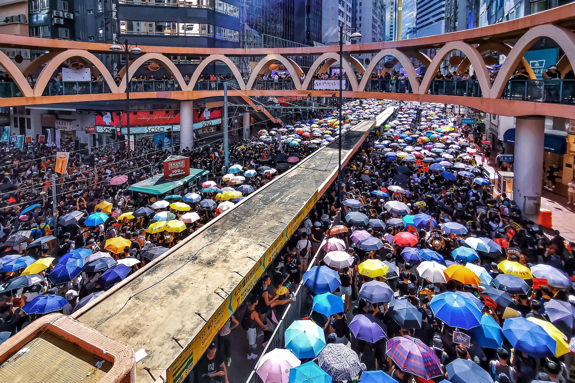 New York Photography Awards Winner - People marching and petitioning with umbrellas raised